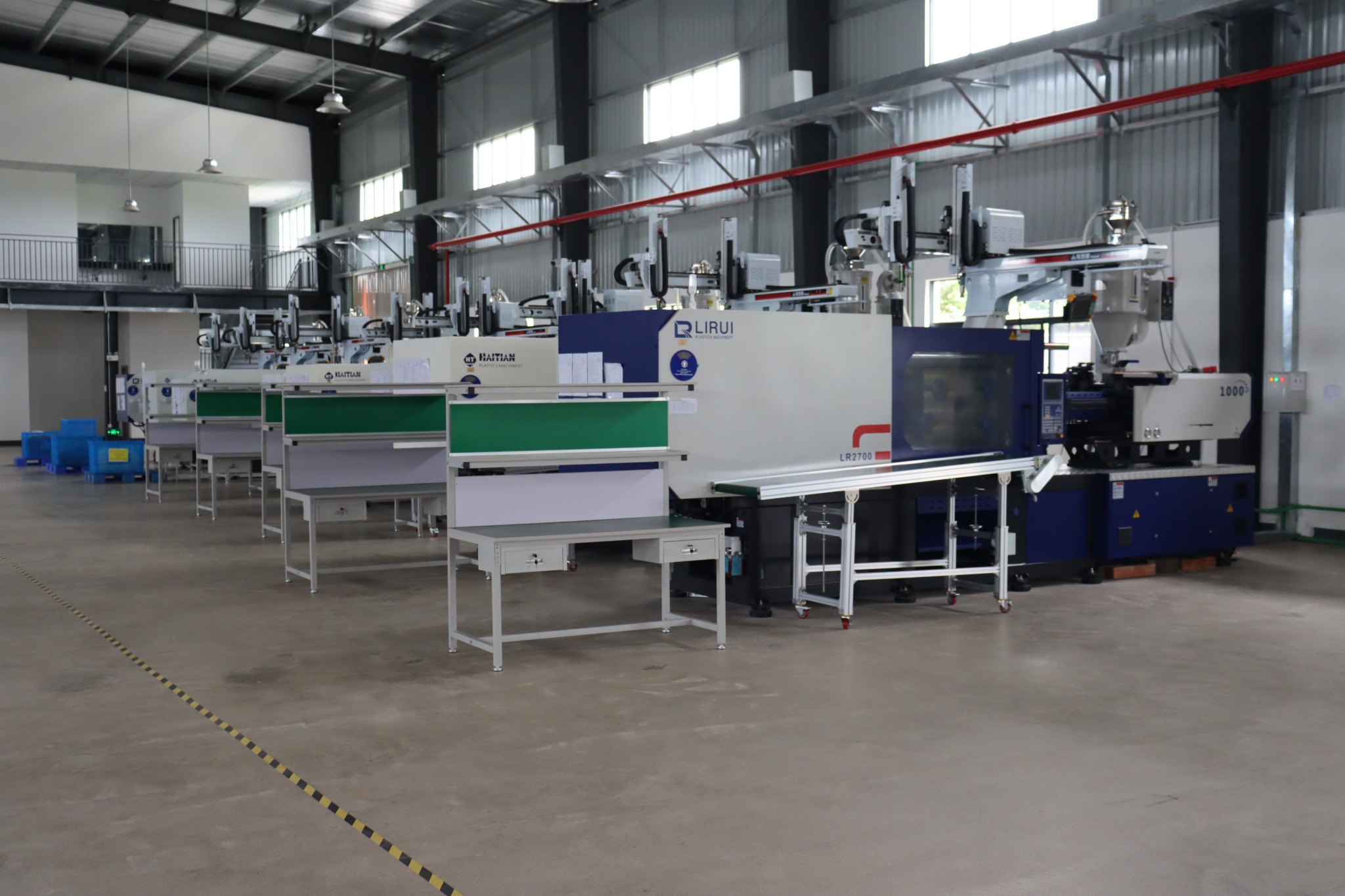 Injection molding production line with machines and workstations